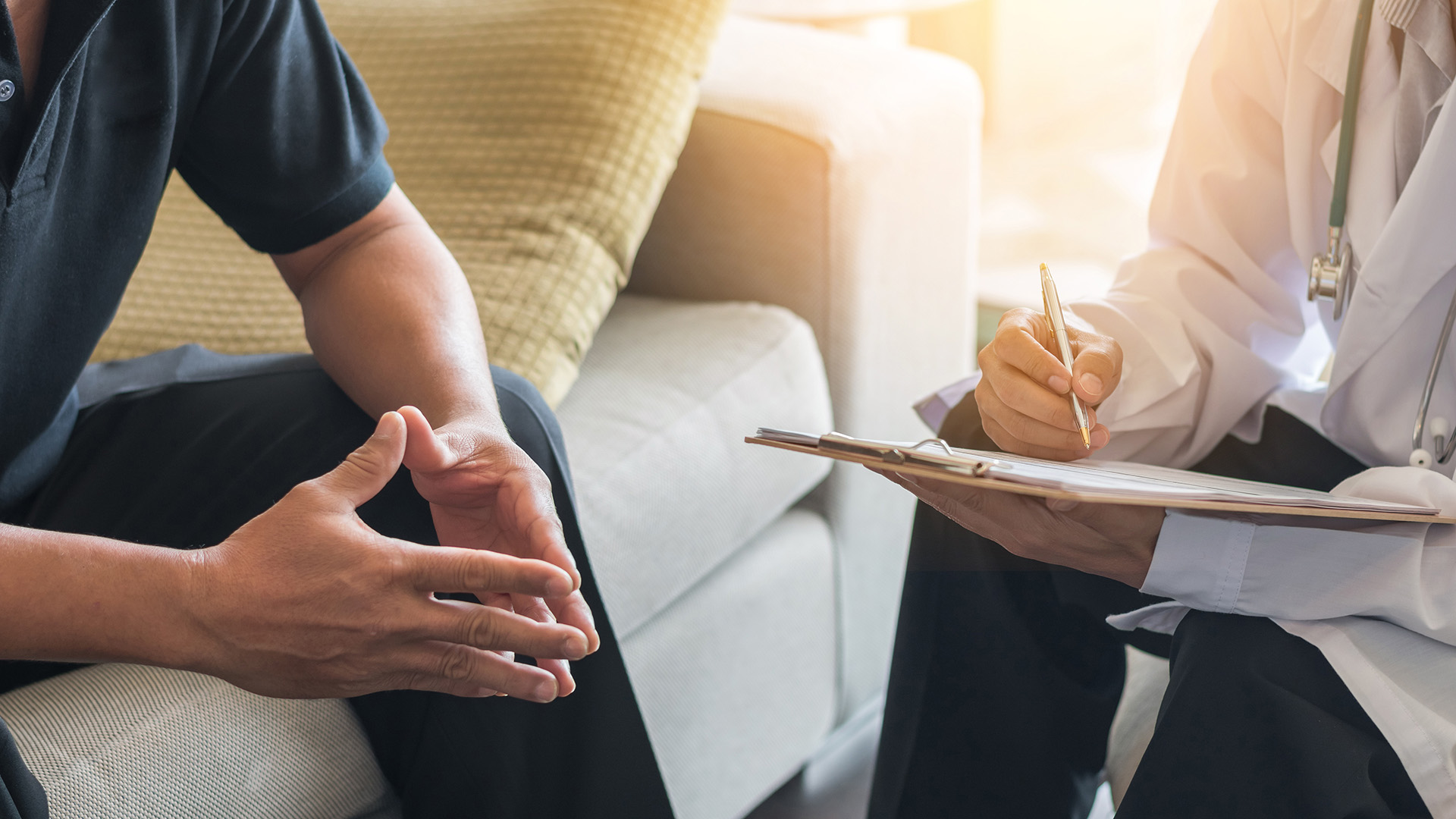 Doctor consulting male patient, working on diagnostic examination on men's health disease or mental illness, while writing on prescription record information document in clinic or hospital office